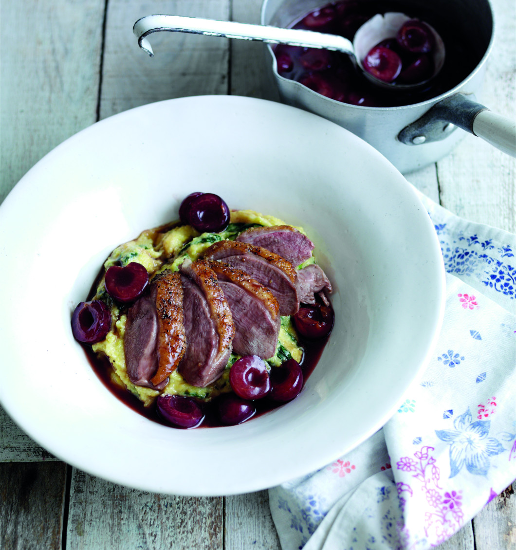 Crispy skinned duck breast with a cherry sauce and creamy spinach and polenta